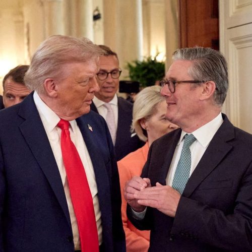 FILE PHOTO: U.S. President Donald Trump talks with British Prime Minister Keir Starmer next to Fr...